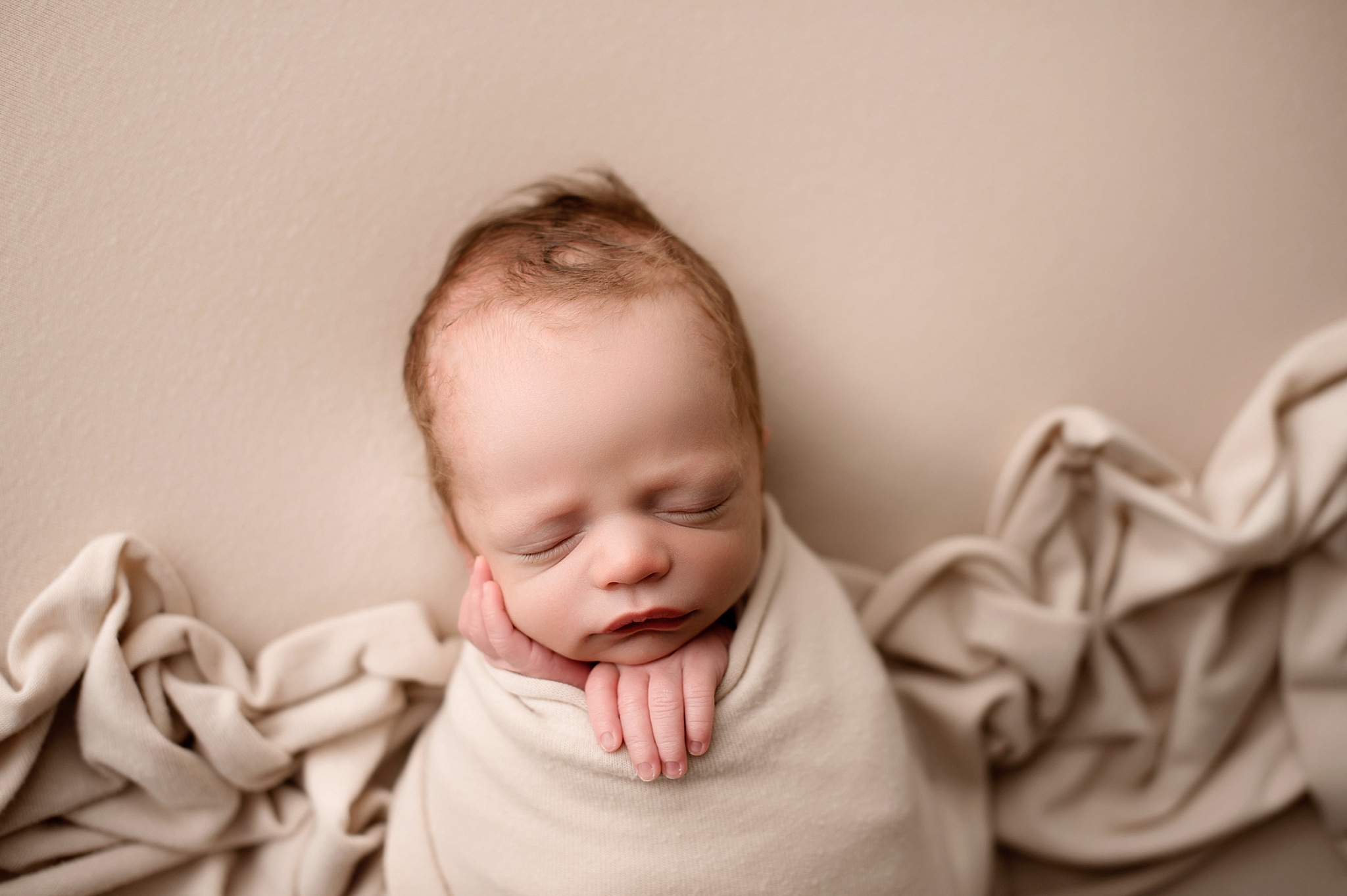 newborn baby wrapped in Bangor Maine photography studio
