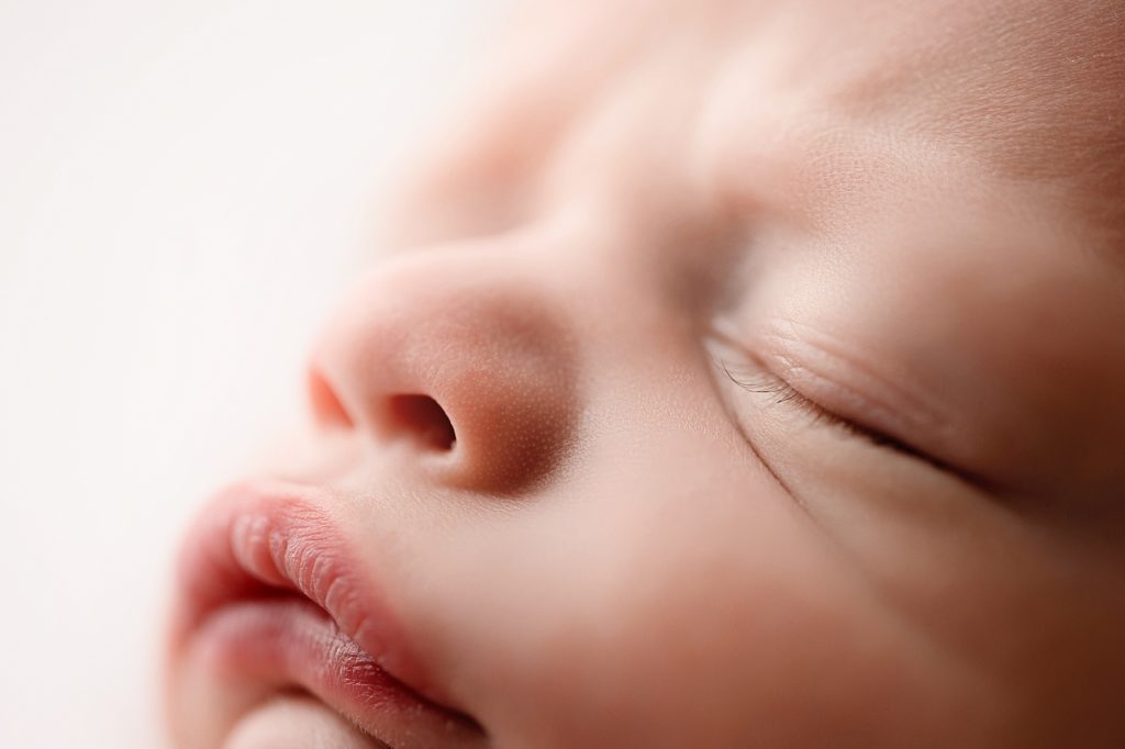 close up of newborn baby eyelashes and pout